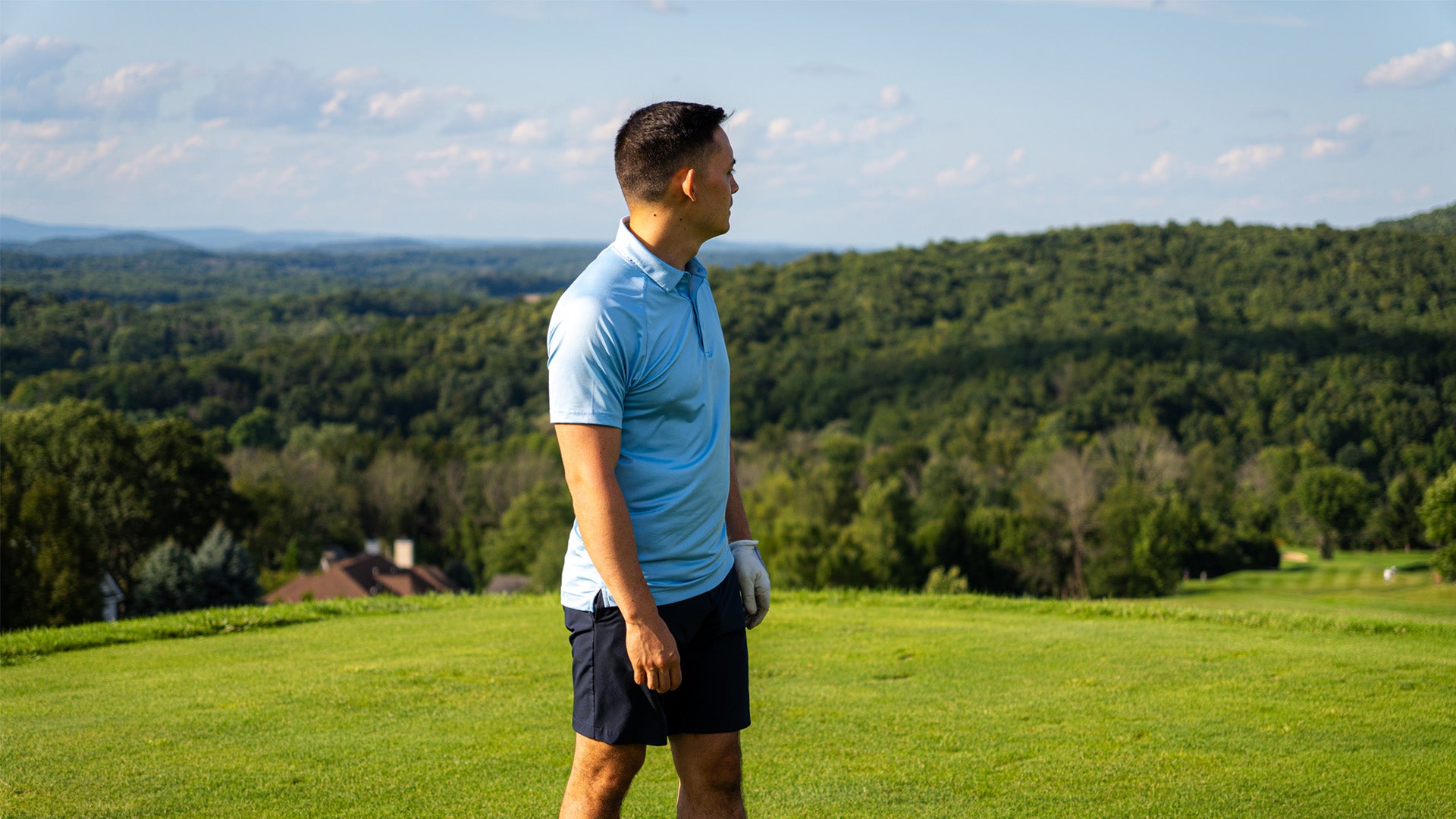 Man on golf course wearing a blue polo