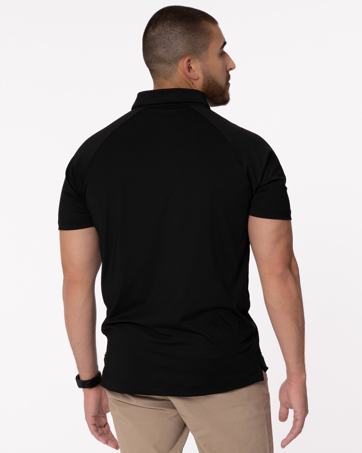 Man modeling back of black golf polo