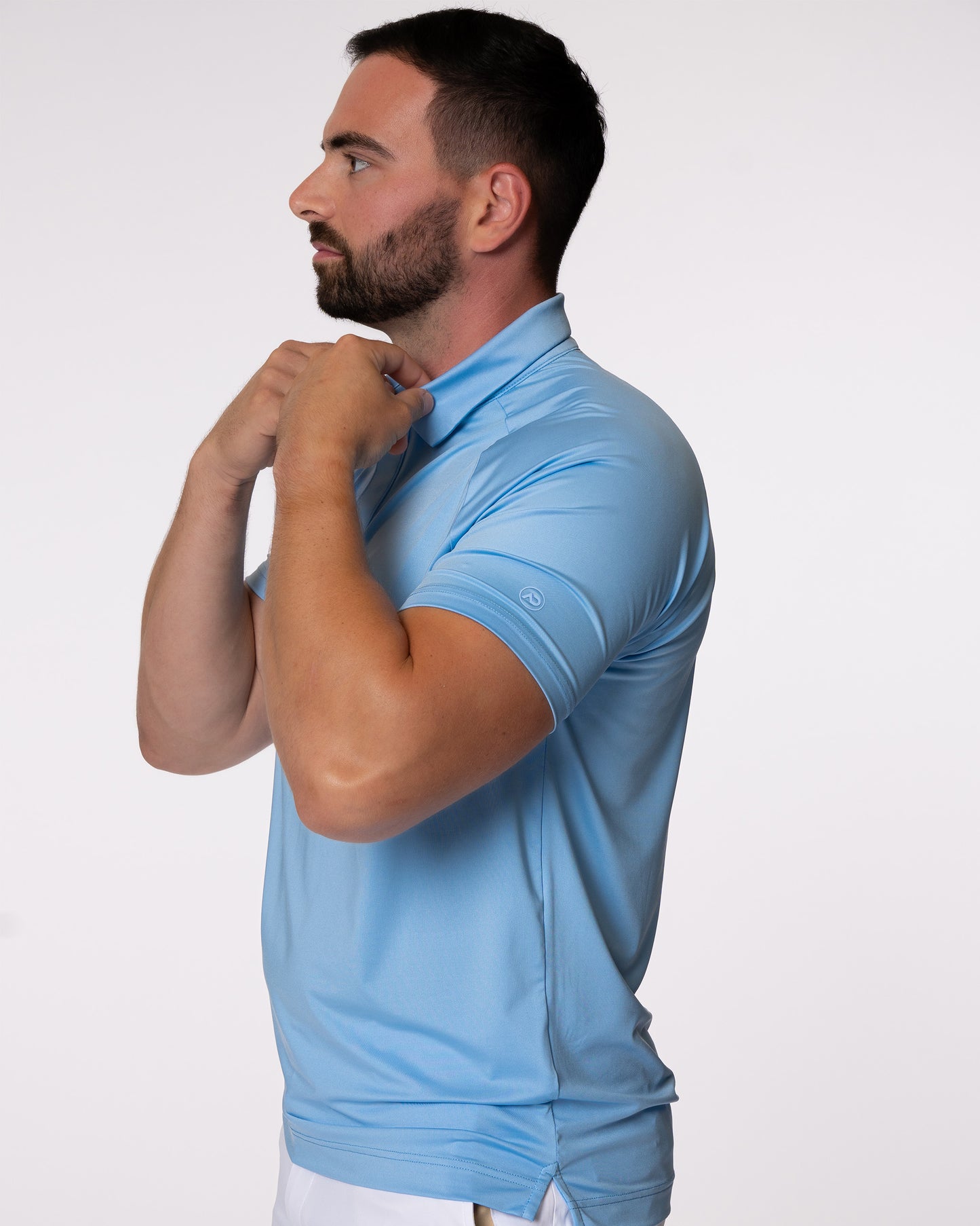 Man grabbing collar of blue golf polo