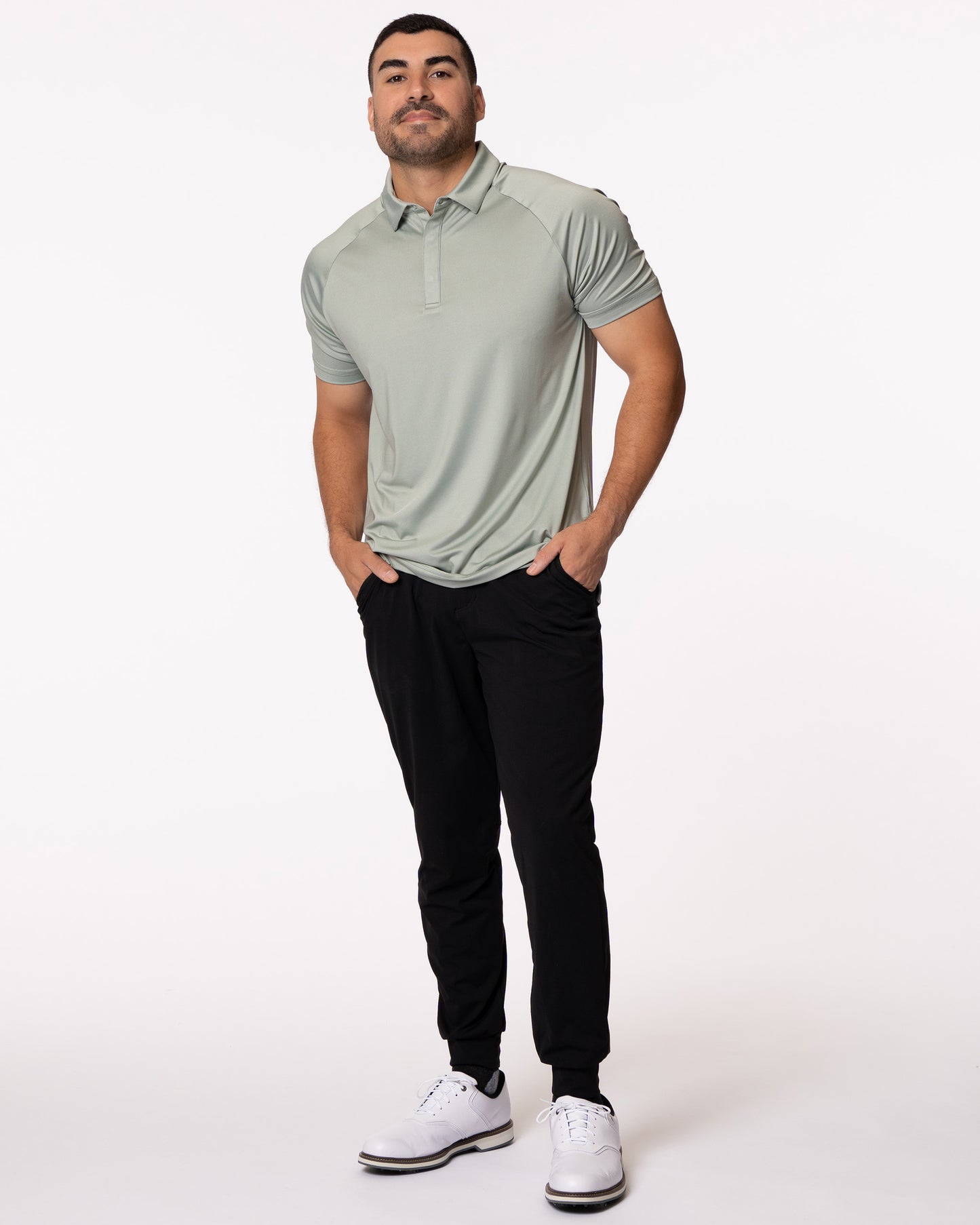 Man smiling with hands in pockets