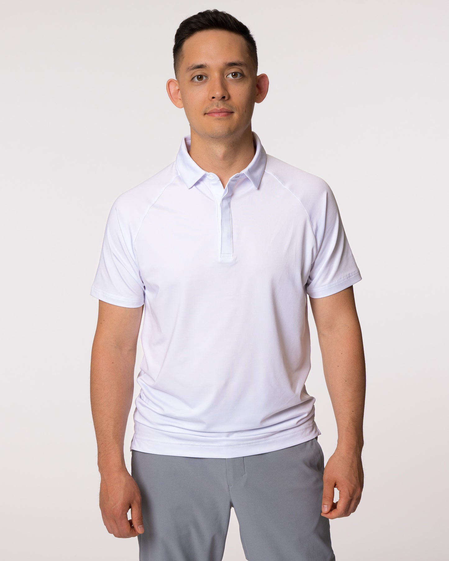 Man wearing white golf polo