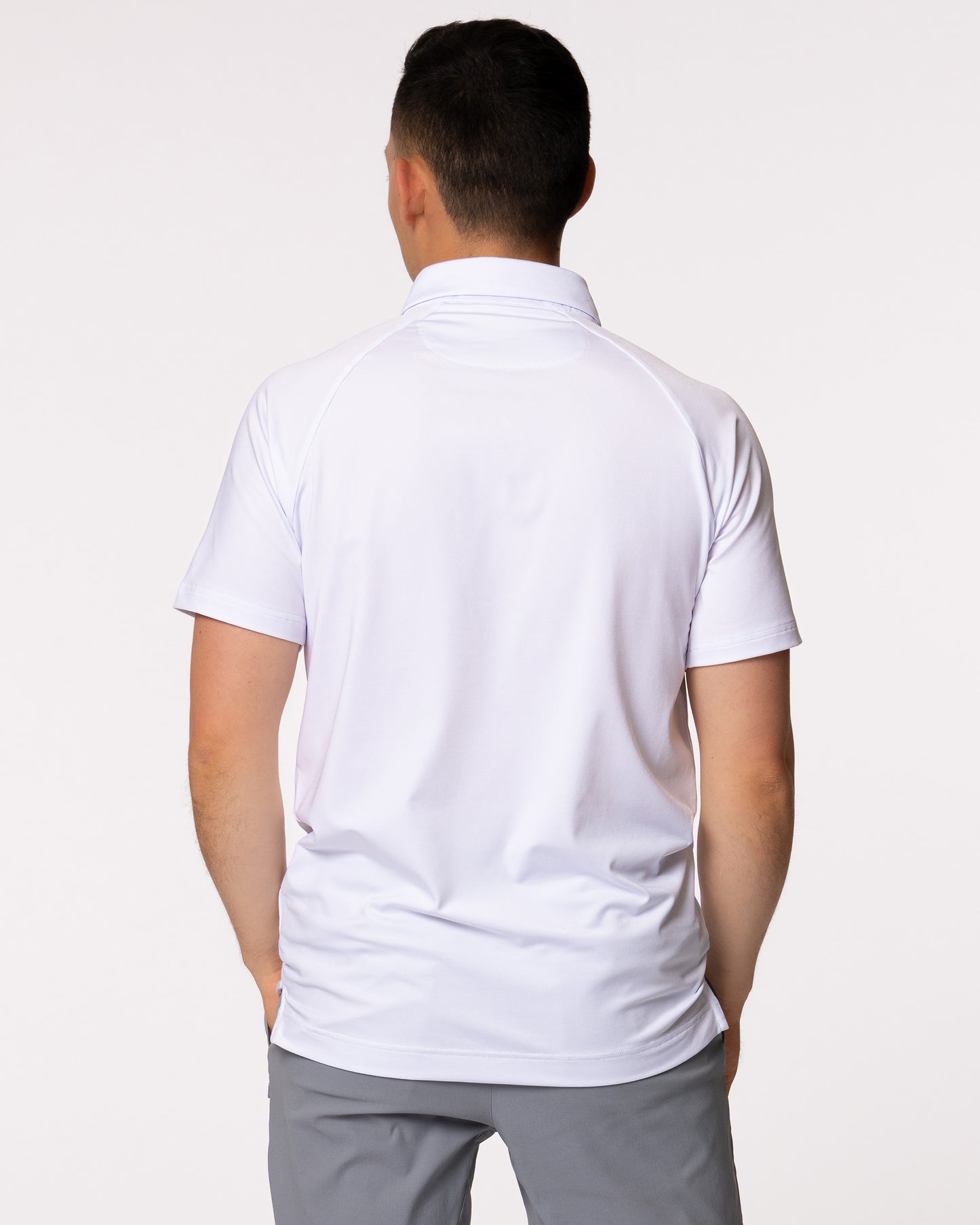 Man modeling back of white golf polo