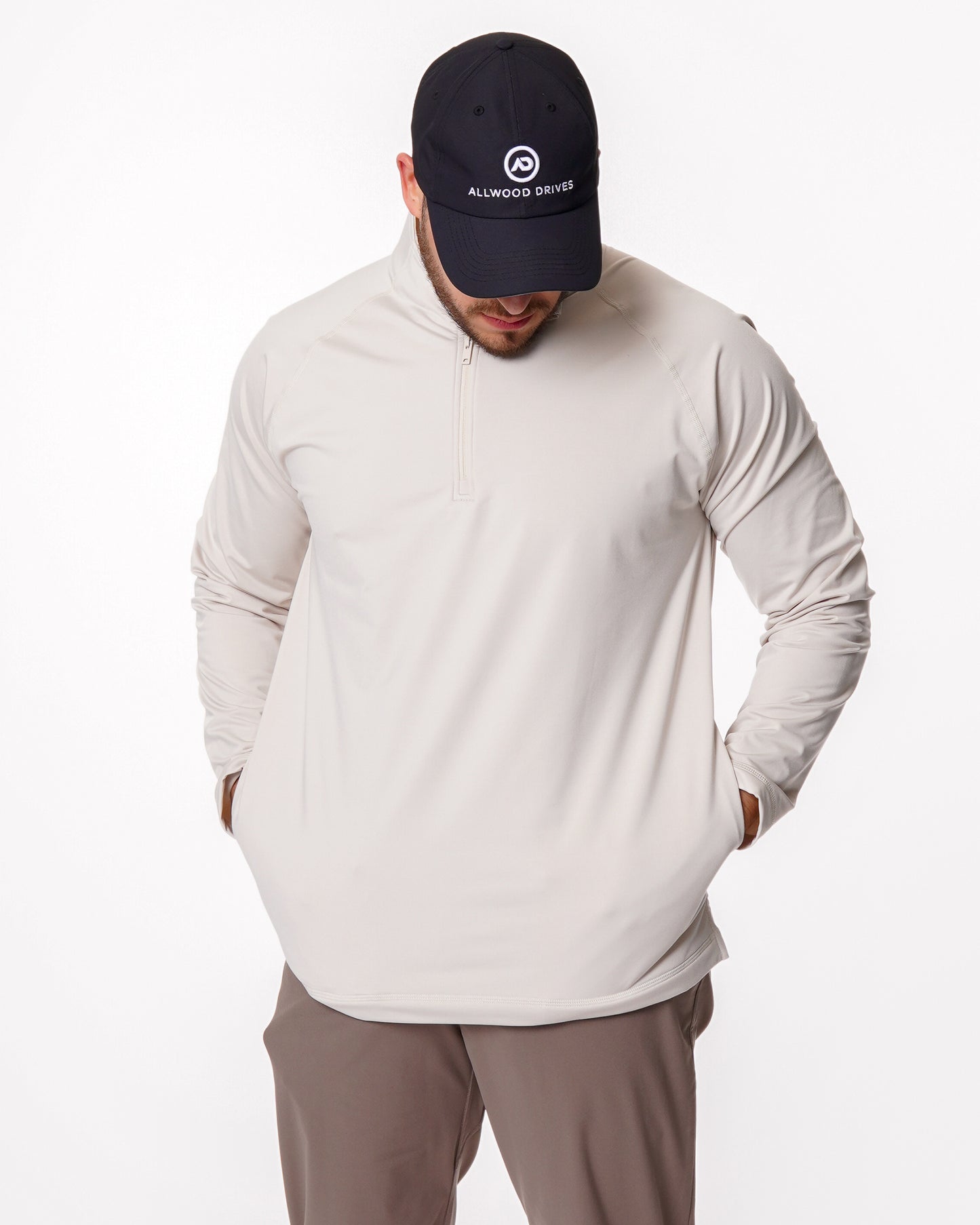 Man wearing a beige quarter zip shirt