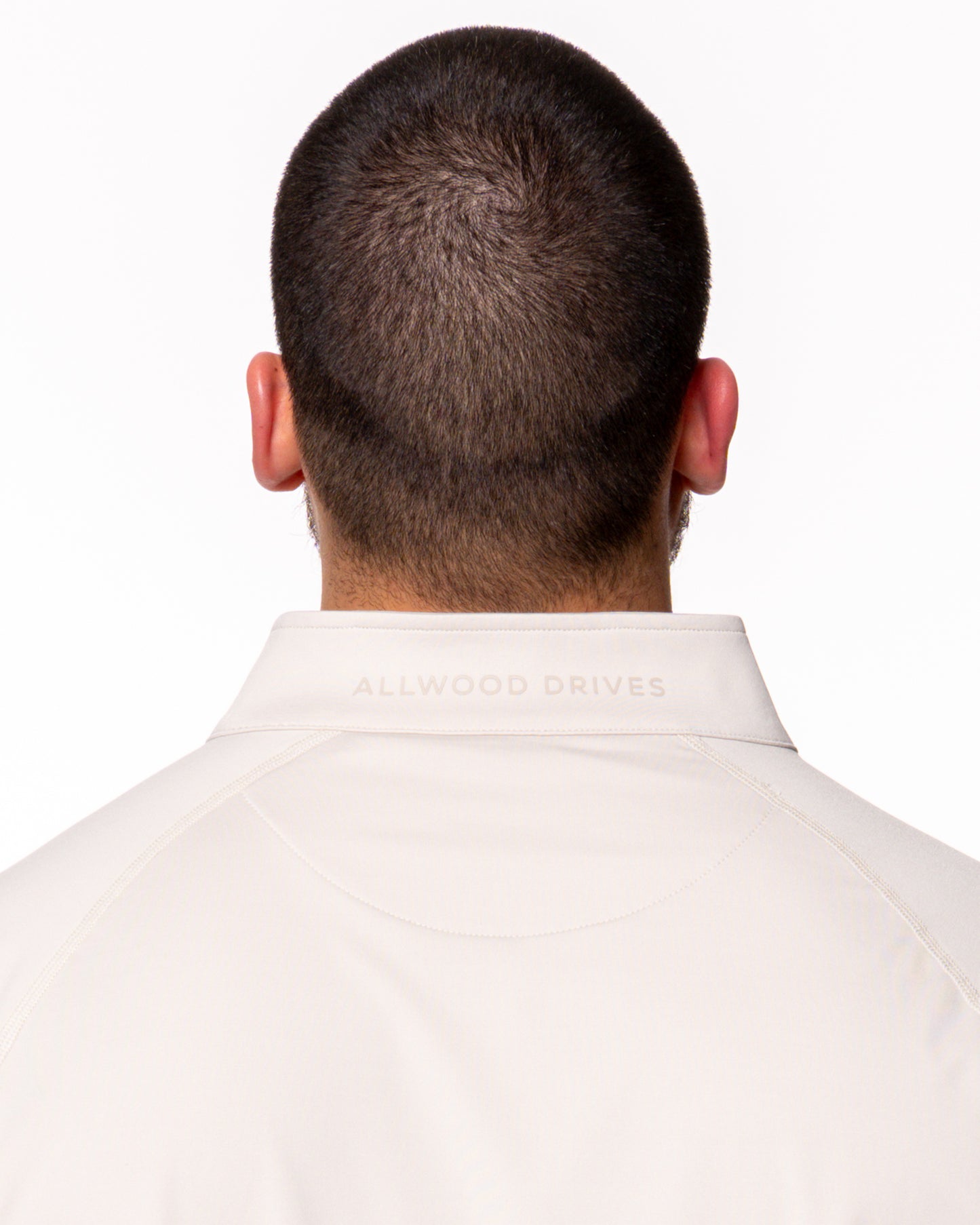 The Allwood Drives logo on back of quarter zip shirt collar