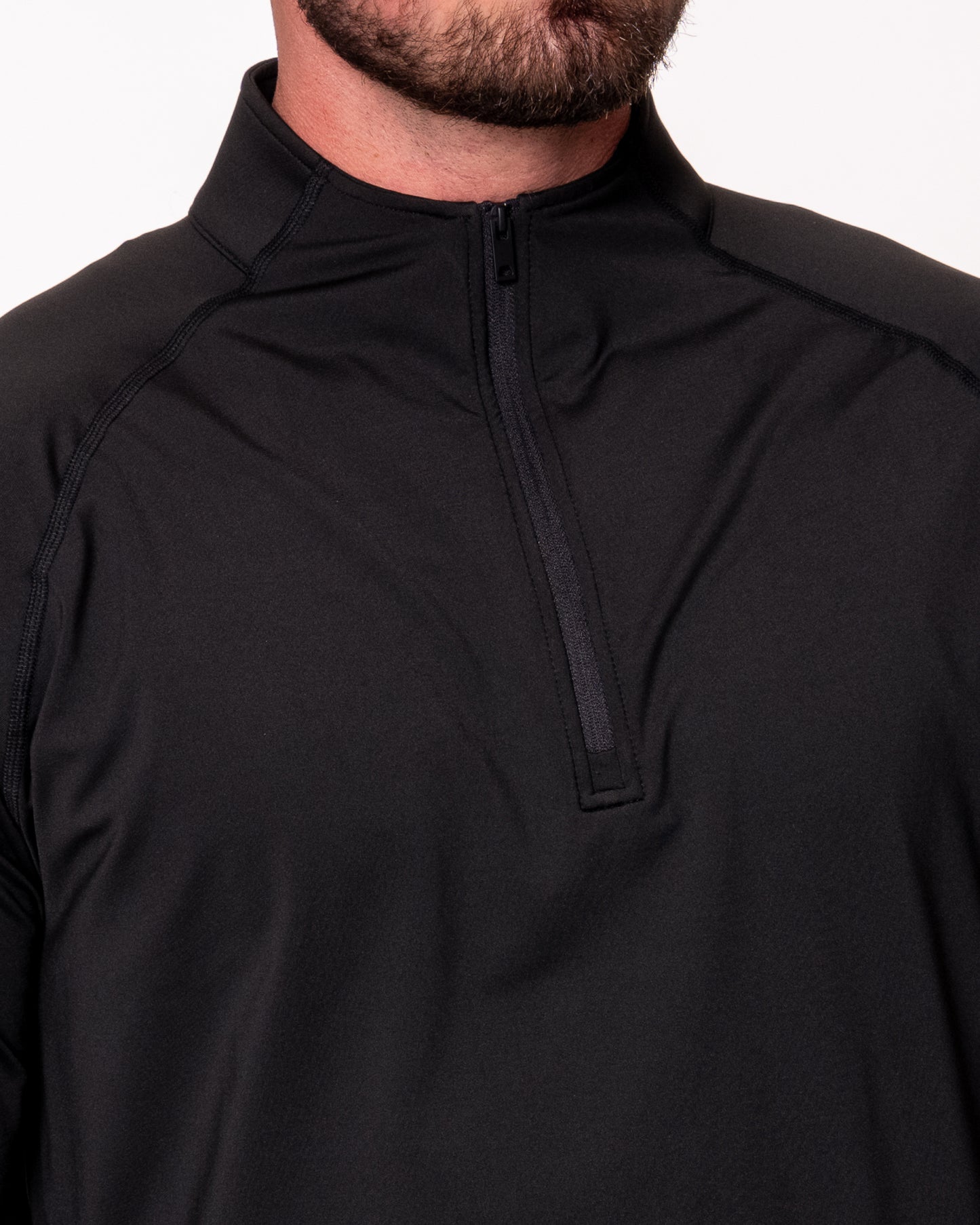 Close-up of front of black quarter zip shirt