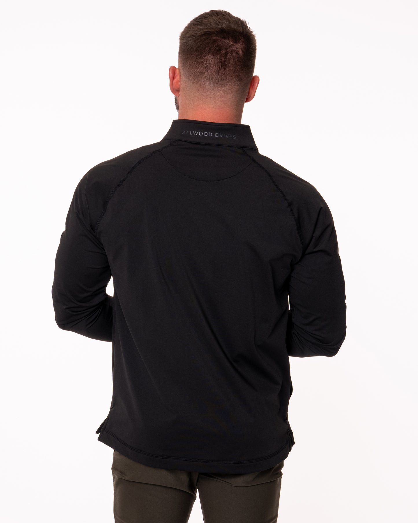 Man modeling the back of black quarter zip shirt