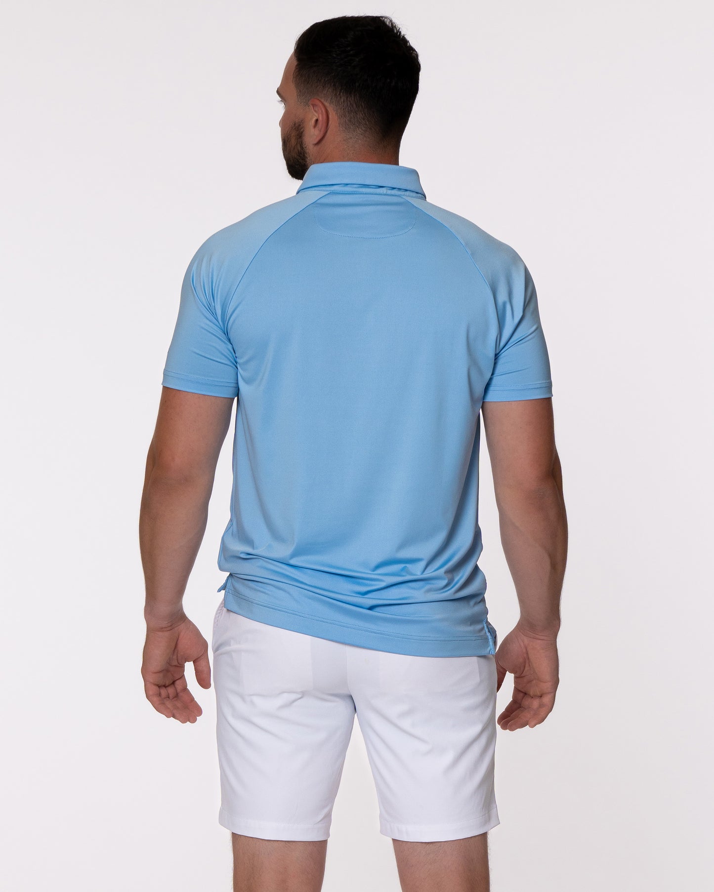 Man modeling back of blue golf polo